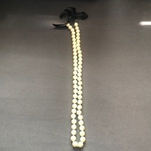 Faux pearl necklace with black bow